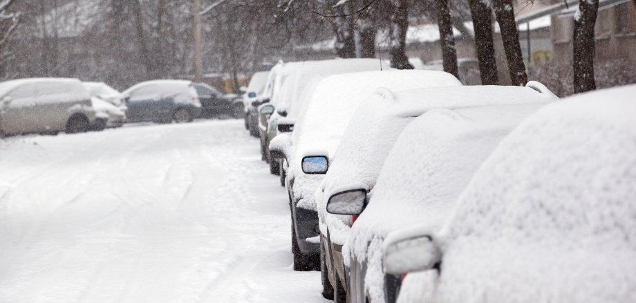 parked cars covered with snow - snow storm